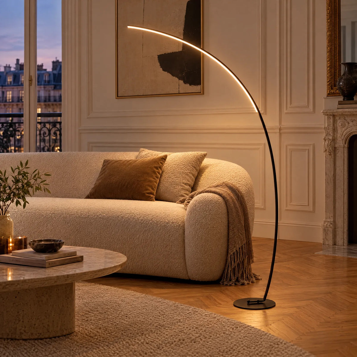 Lampadaire arc LED Kara noir allumé au-dessus d'un canapé dans un salon parisien