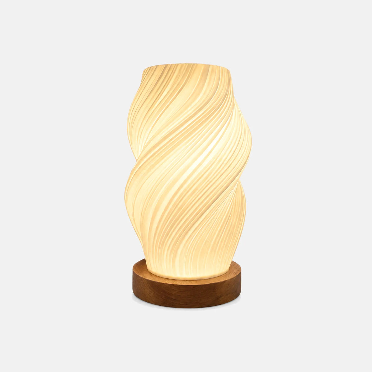 Lampe de table Yva, abat-jour torsadé ivoire sur socle rond en noyer, sur fond uni