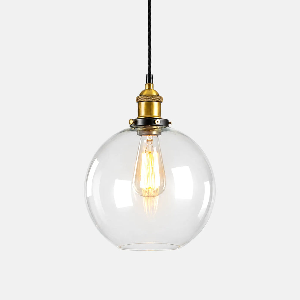 Suspension boule en verre vintage Mora, verre transparent et douille laiton, sur fond uni